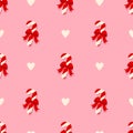 Christmas sugar striped candy with red holiday bow seamless pattern. Pattern with lollipops and hearts on a pink background. Royalty Free Stock Photo